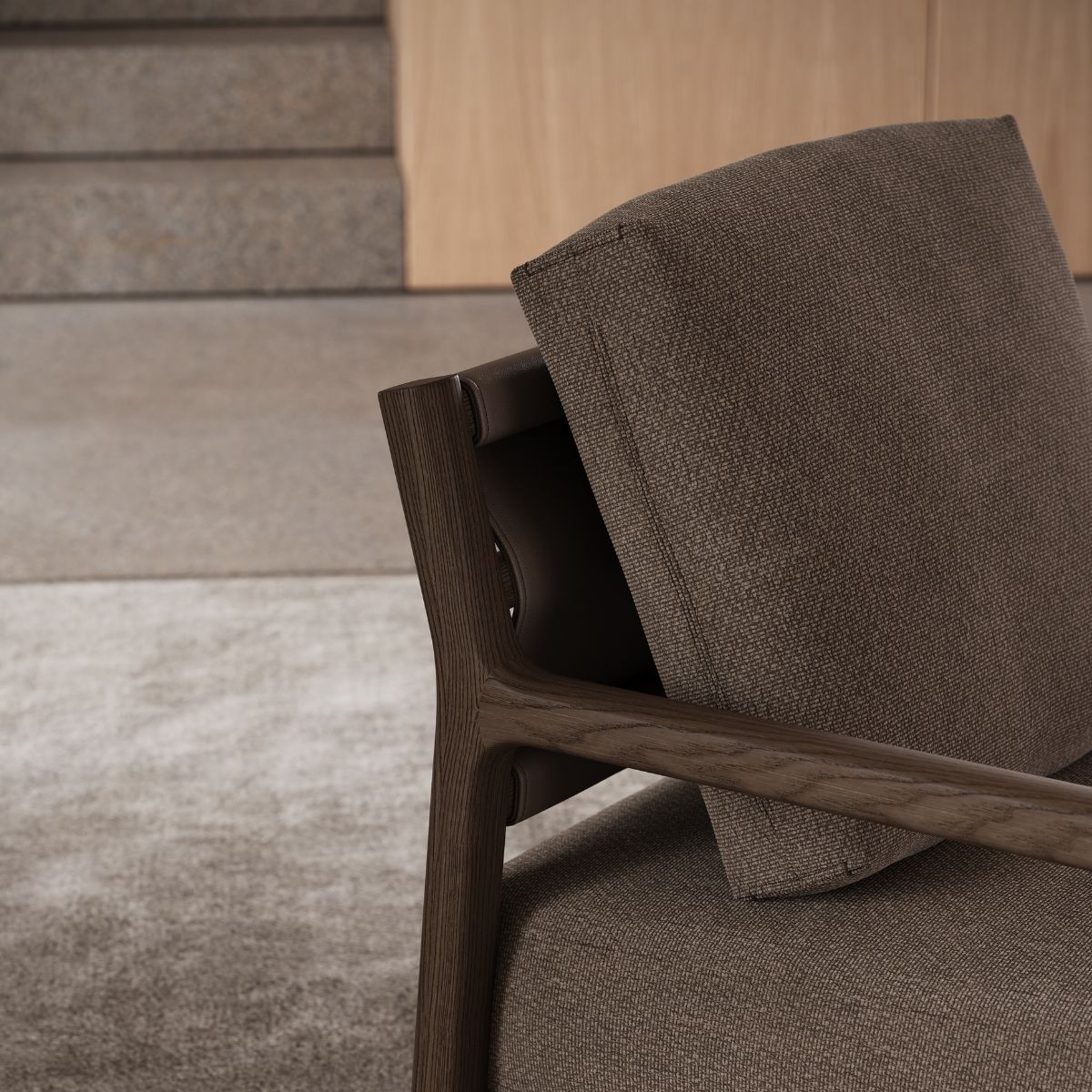 A wooden-framed armchair upholstered in brown fabric, showcasing a simple and elegant design.