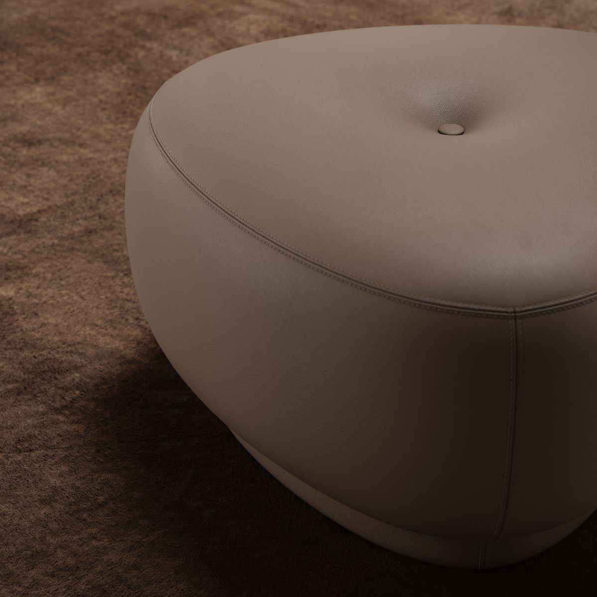 Alton Armchair by Domkapa (8) A triangular brown pouf featuring a plush top, suitable for use as a footrest or additional seating.