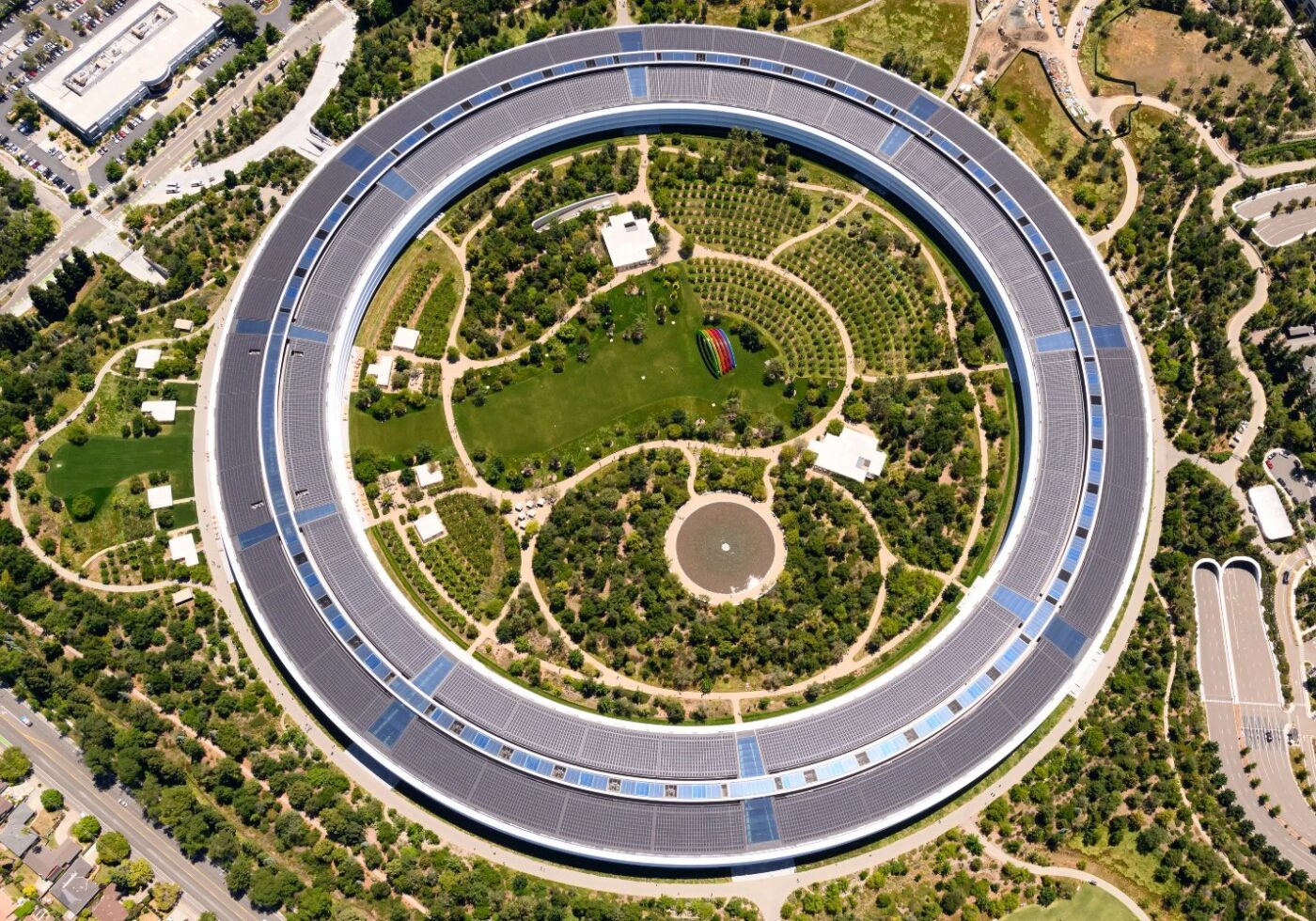 Apple Park by Foster + Partners Apple Park by the architecture firm Foster + Partners. The building is circular with a garden in the middle.