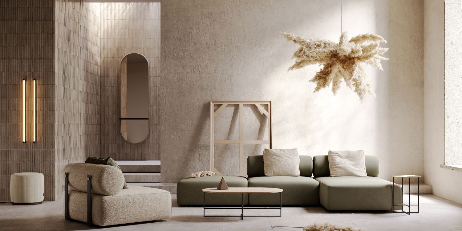 A cosy living room featuring a comfortable modular sofa, an armchair from one of the sofa's modules and a stylish lamp illuminating the space. There is an oval mirror on the back and a white small pouf. In the middle is a table set in metal and wood.