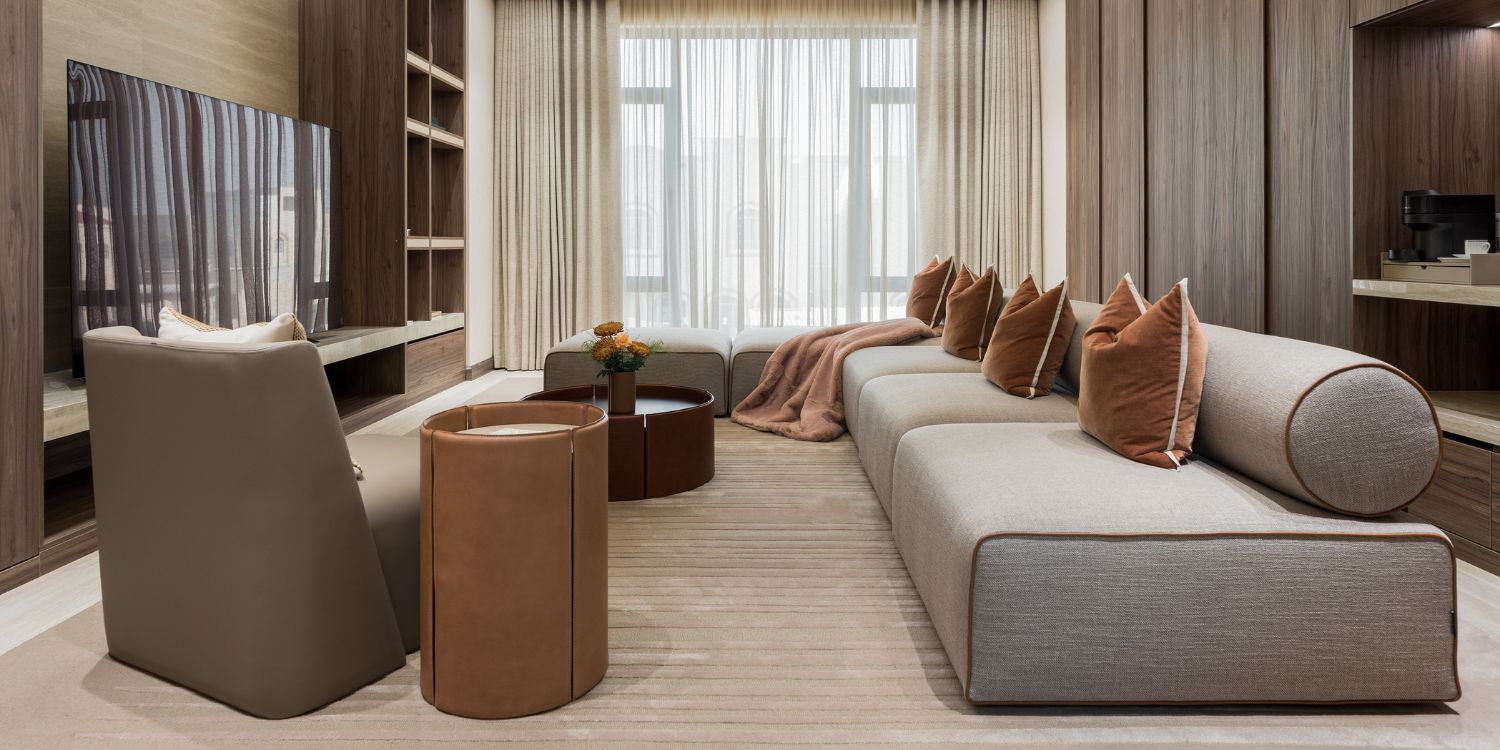 Modern living room setup by Studio Twelve with a comfortable modular sofa, elegant coffee table and a large television for entertainment.
