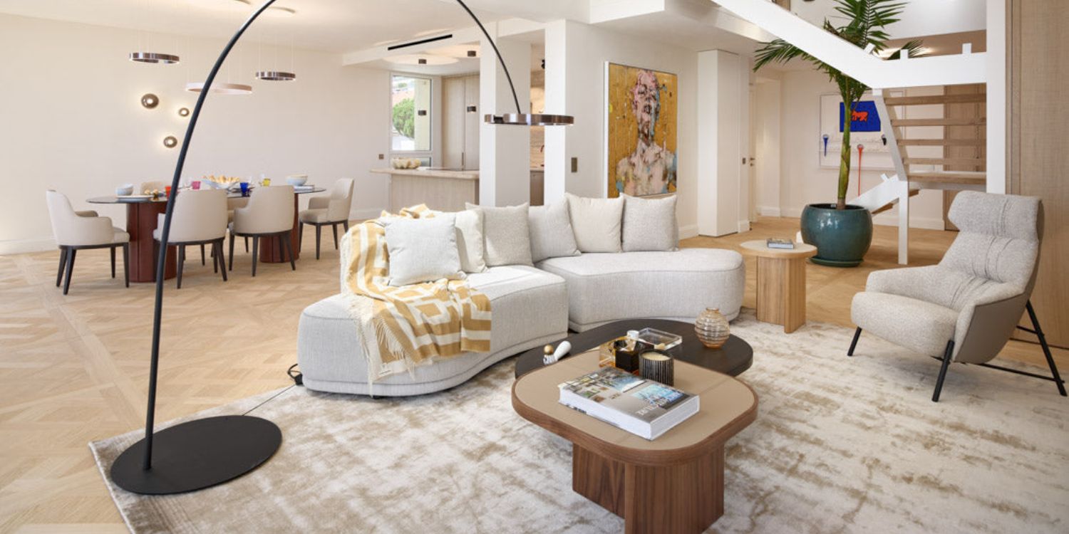 An inviting living room with a modular sofa, a contemporary coffee table, and a lamp enhancing the ambiance. By a french-speaking interior designer.