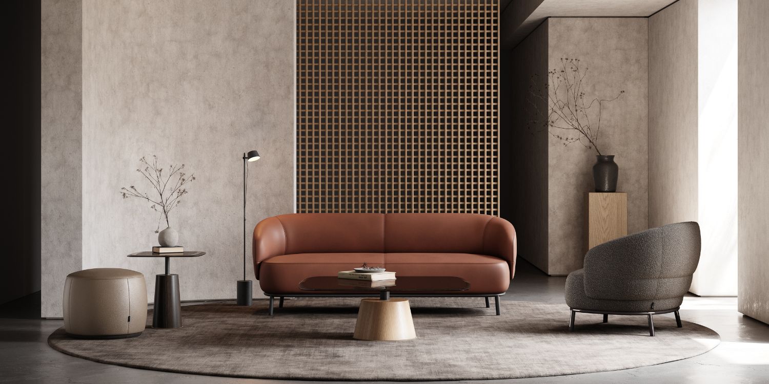 A chic modern living room with a comfortable leather sofa and an armchair in bouclé, perfect for relaxation and socialising. The sofa and the armchair are statement pieces in this living room.