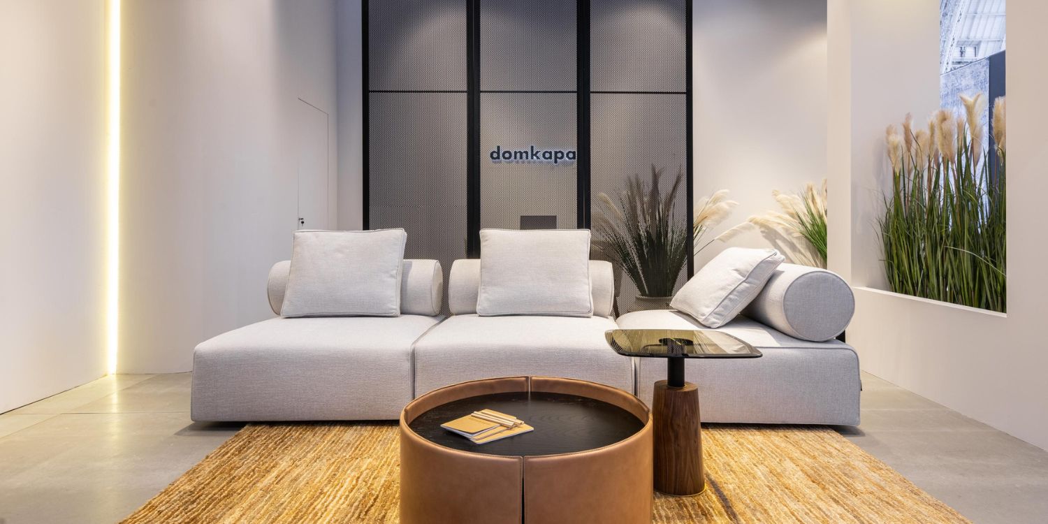 Contemporary space showcasing white furniture and a coffee table, designed for a clean and professional atmosphere. With a white modular sofa and the coffee table is upholstered in leather.