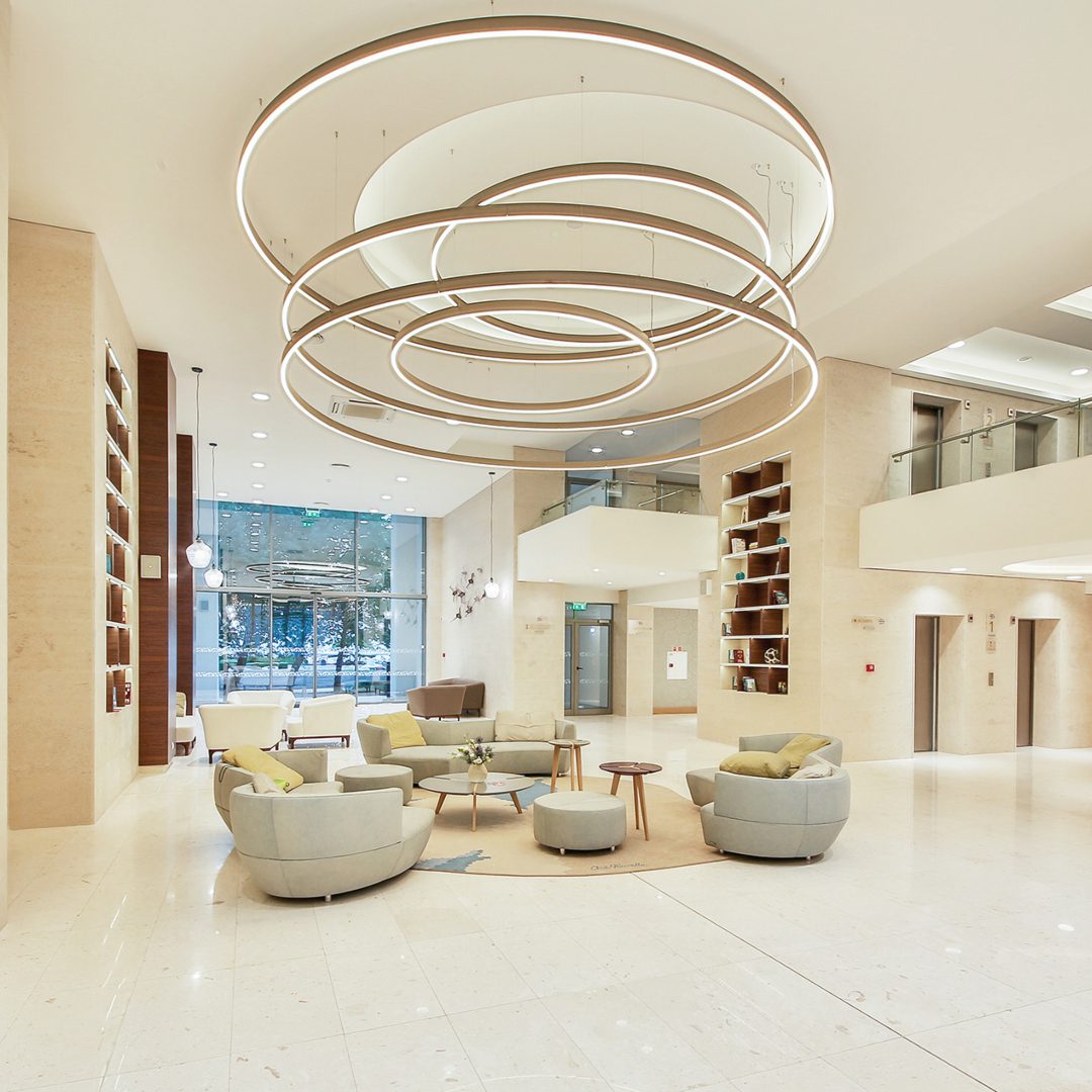Borella Art Design (1) Borella Art Design project. The lobby of an hotel in white tones and grey sofas.
