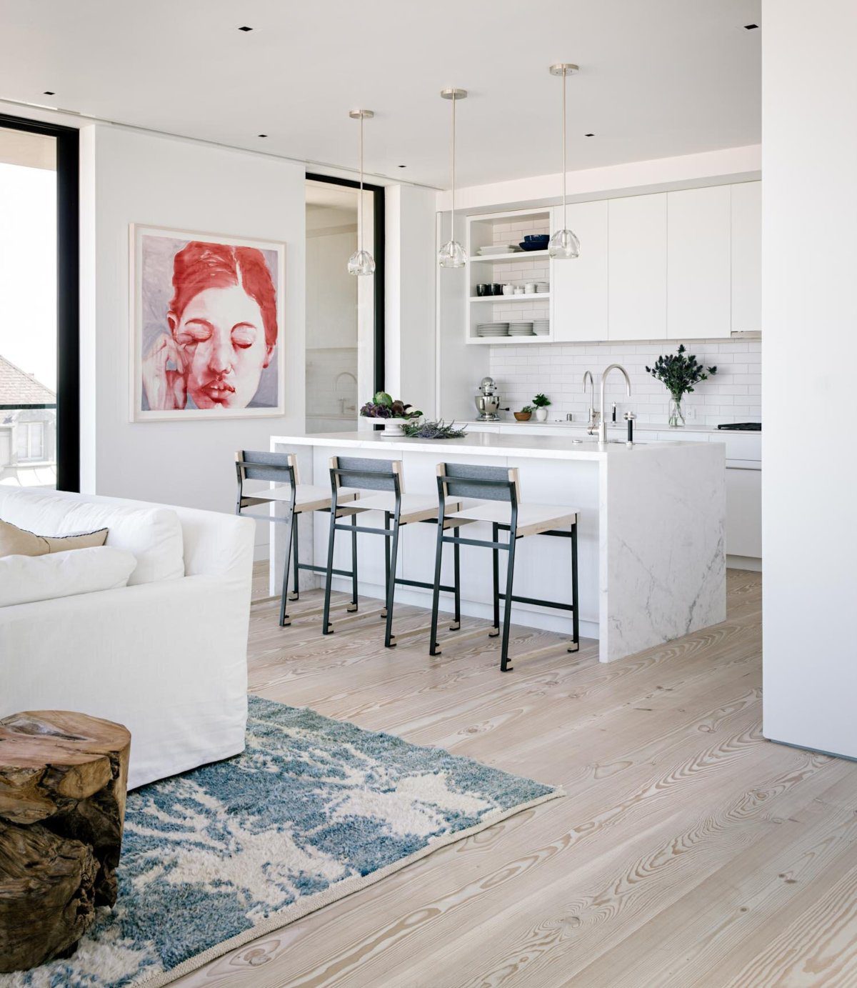 Butterfly House project by Shawback Design Butterfly House project by Shawback Design. The kitchen has a marble counter and three counter chairs in white and black steel.