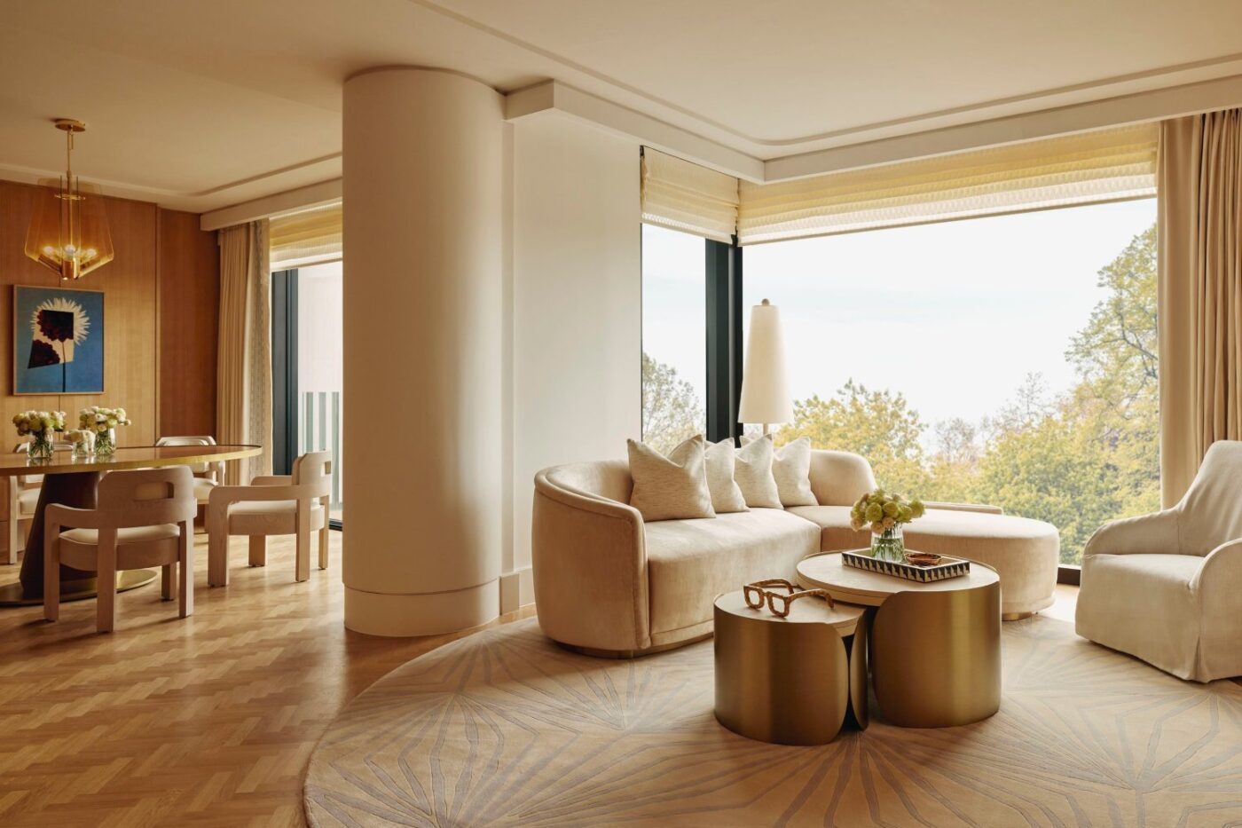 Champalimaud Design Living room design by Champalimaud Design with beige tones and gold accents in the coffee tables.