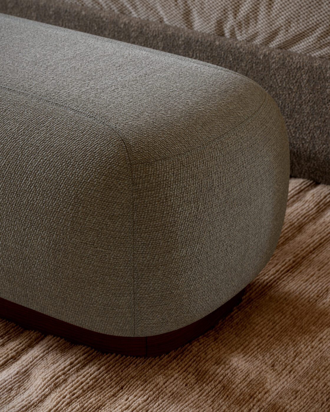 Claire bench details A soft blue Claire Bench is placed on a rich wooden floor, creating a comfortable and modern look in the room.