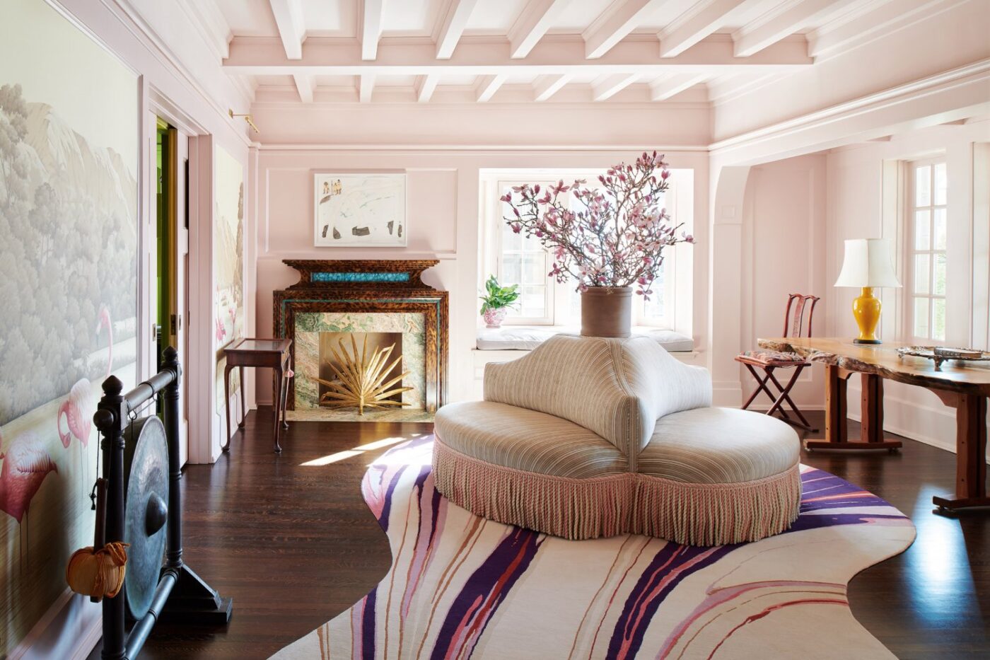 Colette van den Thillart Project by Collette van den Thillart with pink and purple tones. With a sofa in the middle with different tones.