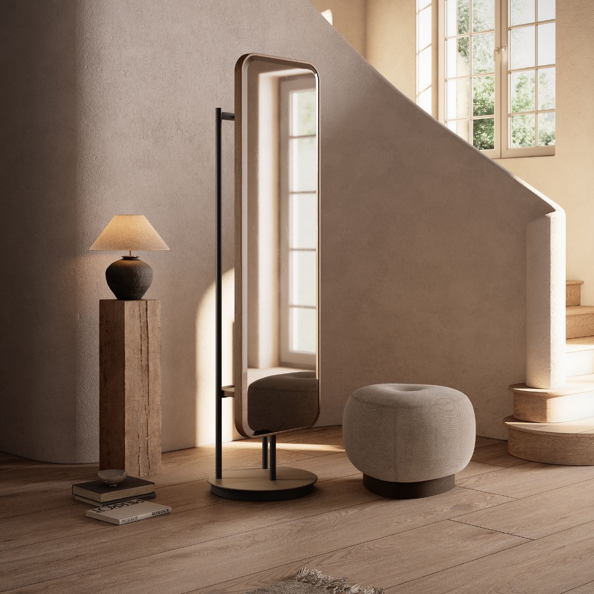 Elise Mirror by Domkapa (4) An entryway with a mirror, a pouf and a lamp, designed for personal grooming or reading in a warm atmosphere.
