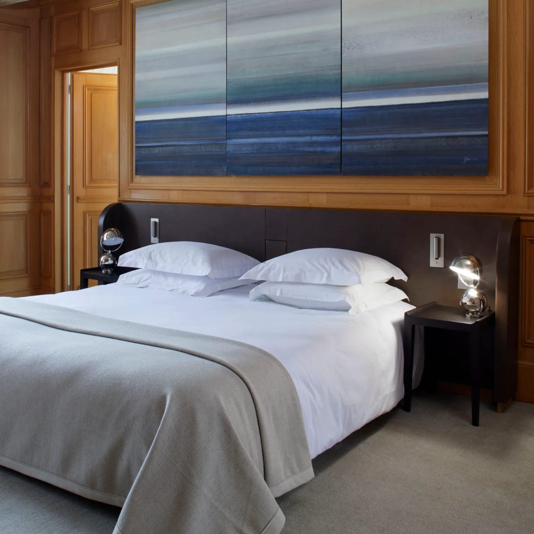 Elliot Barnes Bedroom project by Elliot Barnes. With a blue tones art piece on top of the bed. The bed has a dark toned wood headboard.