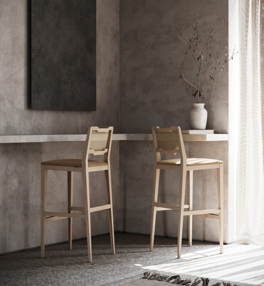 Eva family - Eva bar and counter chair A room showcasing two wooden stools alongside a vibrant painting, enhancing the space's aesthetic appeal.