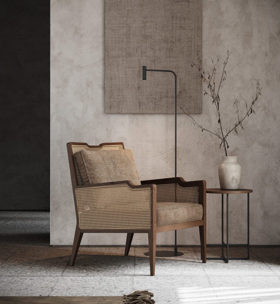 Eva family - armchair An armchair in wood and rattan and a table set before a wall, illustrating a straightforward and functional interior design.