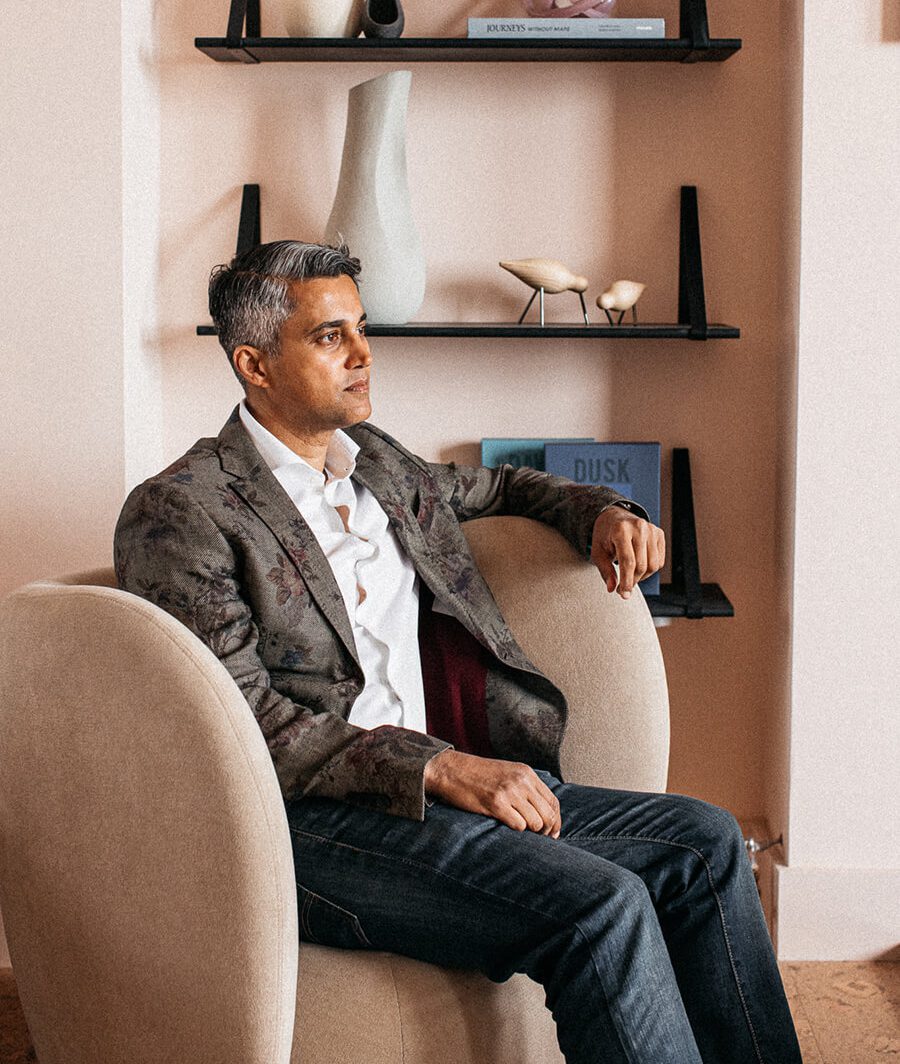 Imraan Ismail Imraan Ismail, the interior designer behind the Port Hotel project. This photo was taked in the restaurant of the hotel and it has pink tones and an armchair in neutral velvet.