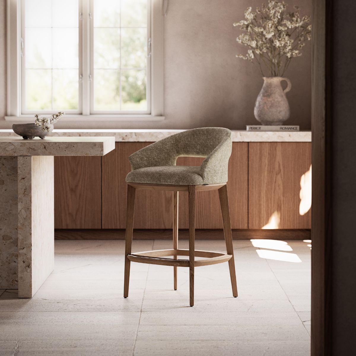 Jermain Bar Chair by Domkapa (2) Modern bar chair with a textured gray fabric seat and wooden legs, set against a marble bar. The muted tones create a cozy, elegant atmosphere.