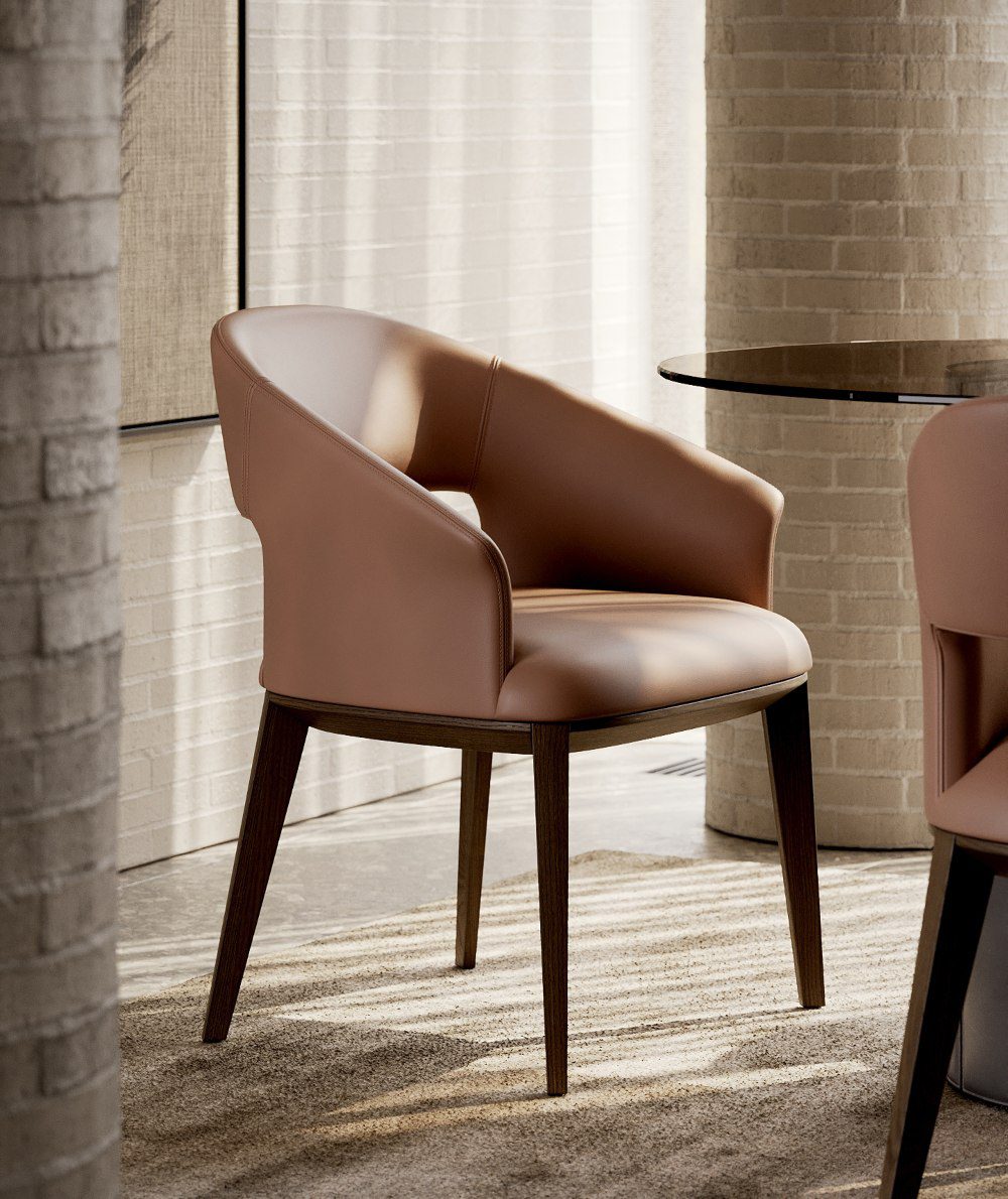 Jermain chair in mocha mousse (1) A contemporary chair designed with a mocha mousse leather seat and wooden legs, offering comfort and aesthetic appeal.