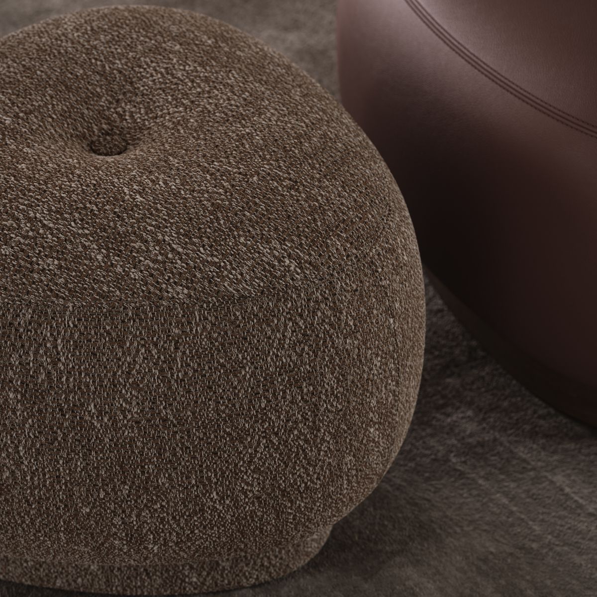 Jules Pouf by Domkapa (2) A brown pouf rests on a matching brown rug, creating a cosy and harmonious living space.