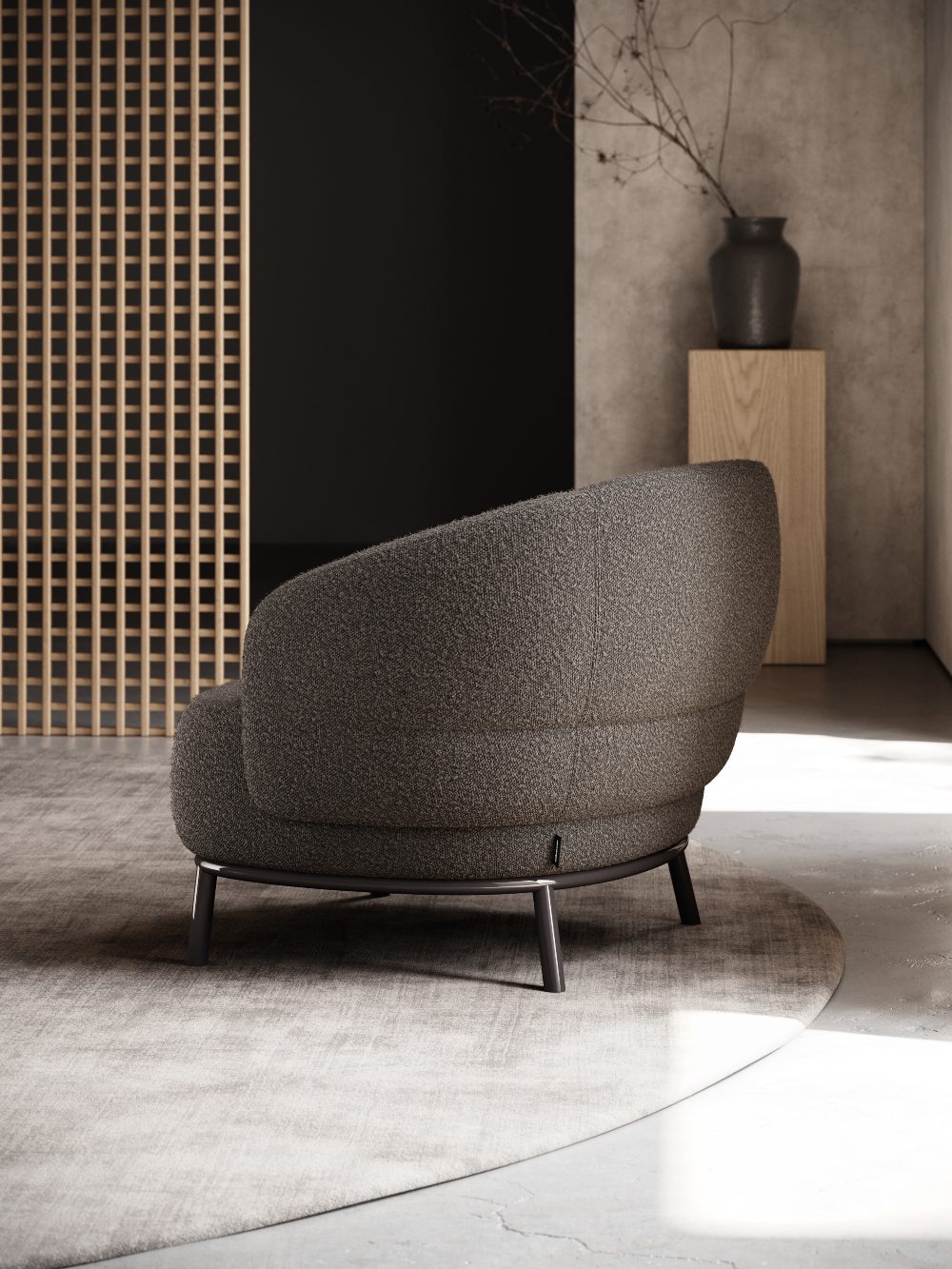 Juliet armchair in a living room corner A modern armchair in a room with a natural wooden wall, creating a warm and inviting atmosphere. One of the statement pieces of this space.