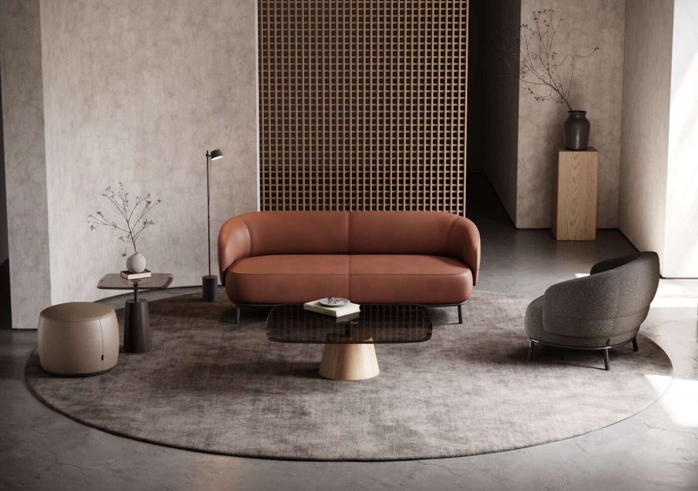 Juliet sofa and armchair by domkapa A contemporary living room featuring a round sofa, an armchair and pouf, creating a cosy and inviting atmosphere.