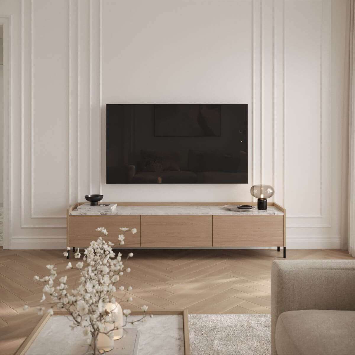 Kaizen Design Studio project with Domkapa pieces A modern living room showcasing a wall-mounted television and minimalist furniture design.