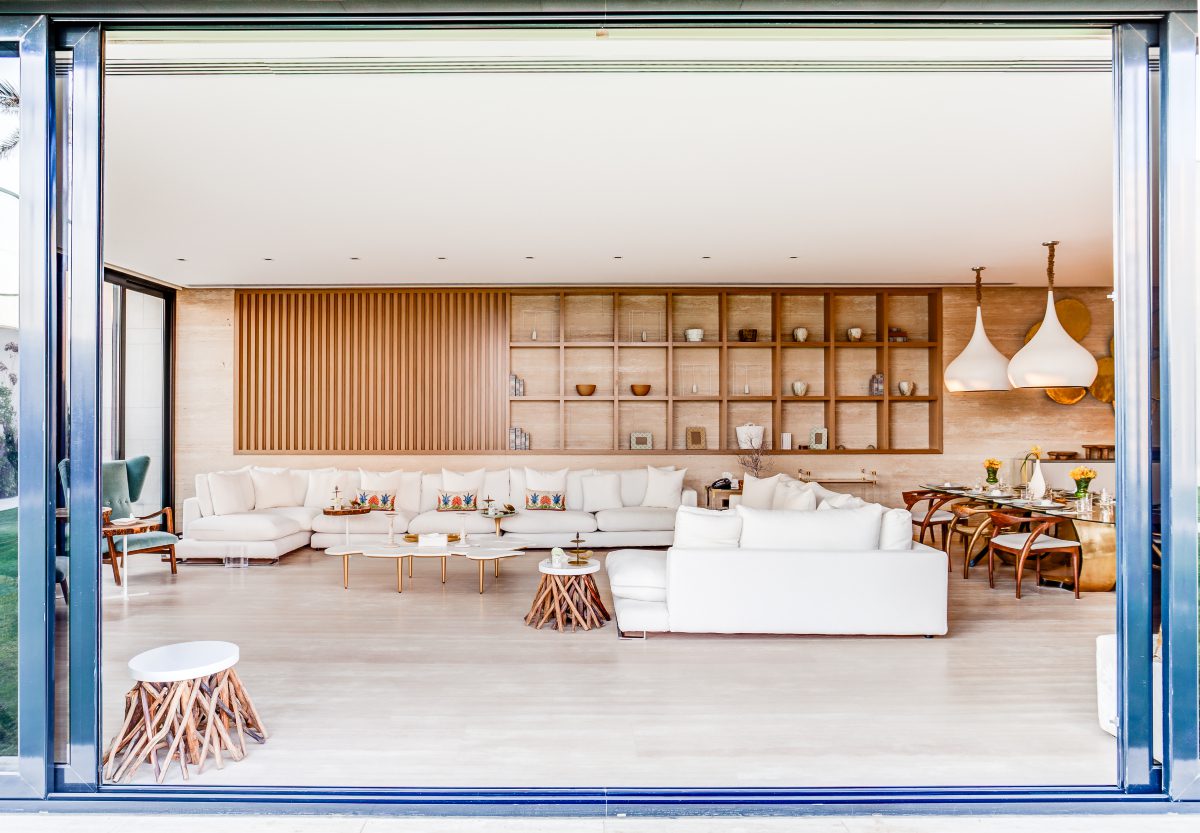Laura Carrillo Project Living room project with a white sofa and wood accents in the coffee tables. With beach vibes.