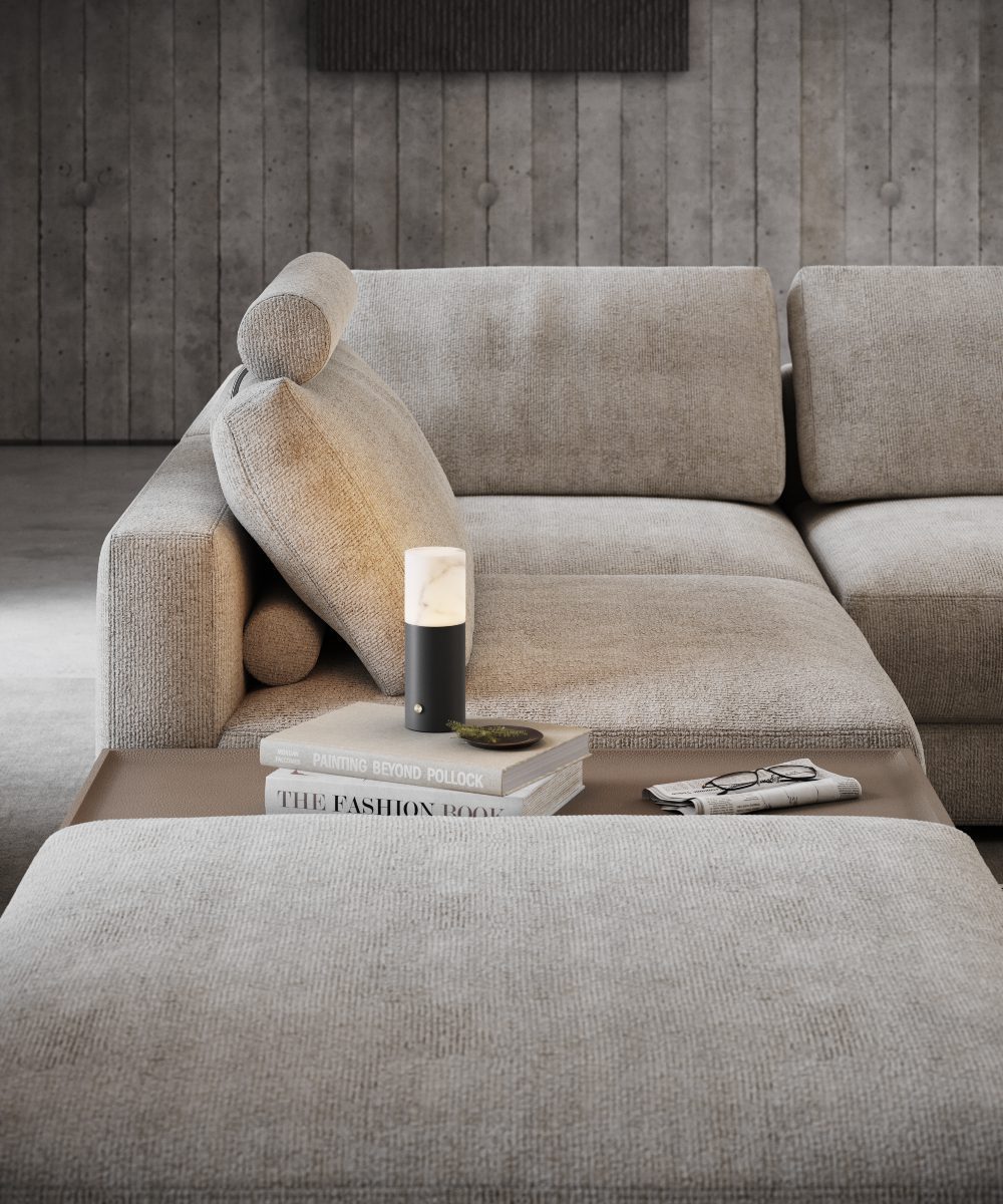 Living room with Edward Sofa Modular sofa with a table module that has a small table lamp with a soft light.