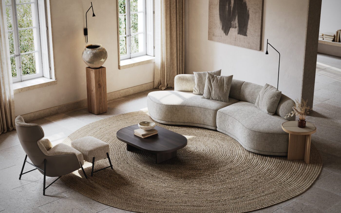Living room with Olivia sofa and Hubert Armchair A hygge living room showcasing a large round rug paired with a modular sofa, enhancing the room's warmth and comfort.