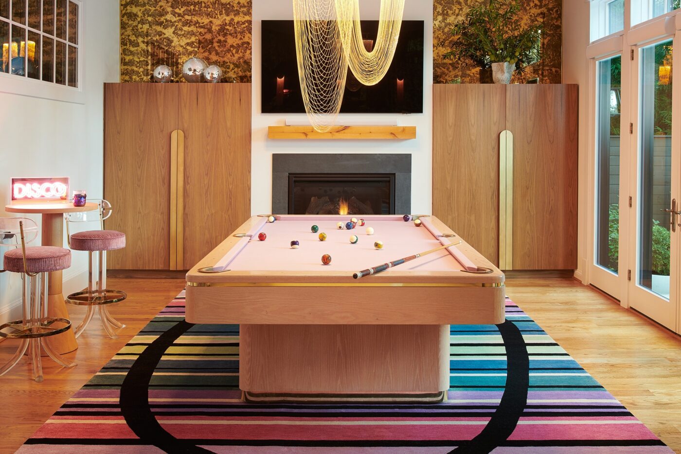 Mid Atlantic project by J.Fisher Interiors Colourful game room in the Mid Atlantic project. It has pink bar chairs and a pink 8 ball table. Also has a very colourful carpet.