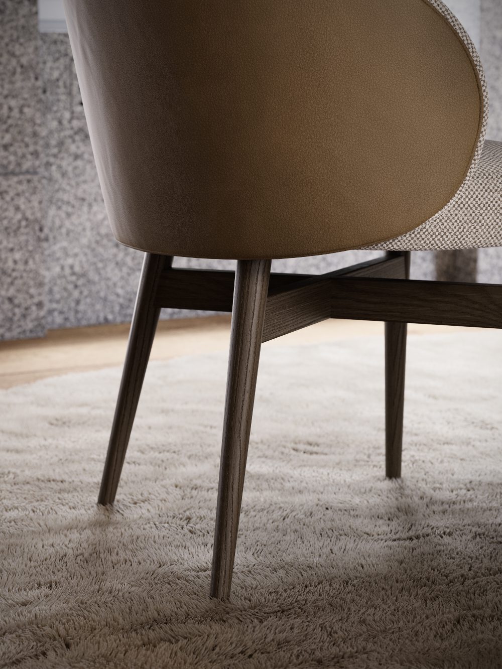 Norah Chair back - custom upholstery Back of a dining chair upholstered in light brown leather and with four wooden legs.