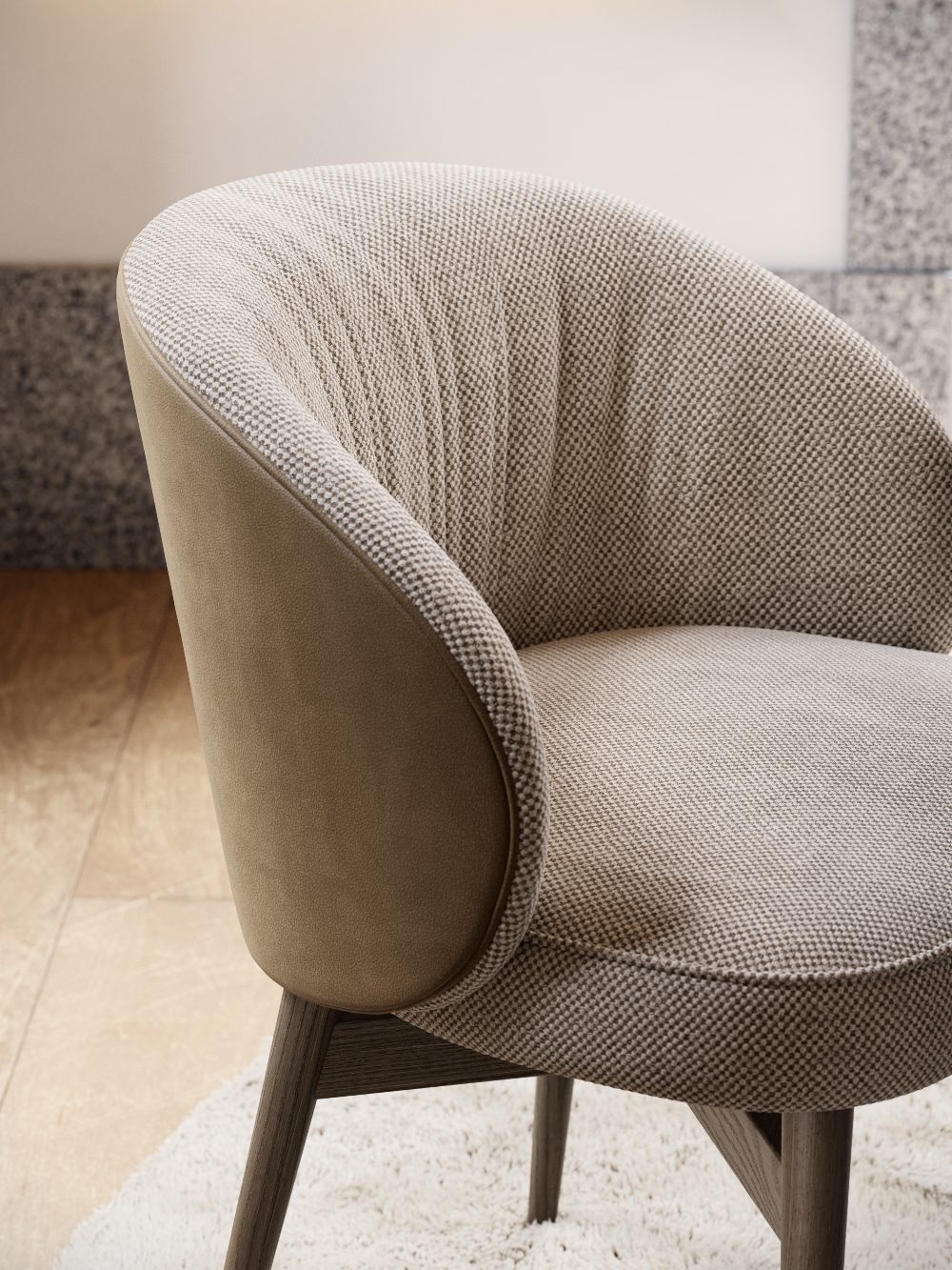 Norah Chair front Dining chair upholstered in the front and with leather on the back. In brown and neutral tones.