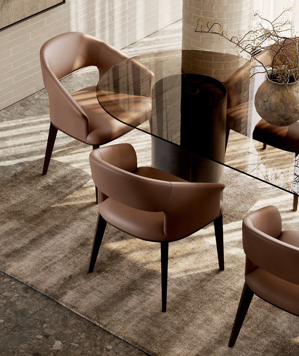 Pantone Mocha Mousse and Domkapa A minimalist dining table accompanied by chairs, adorned with a vase, exemplifying modern design and sophistication.