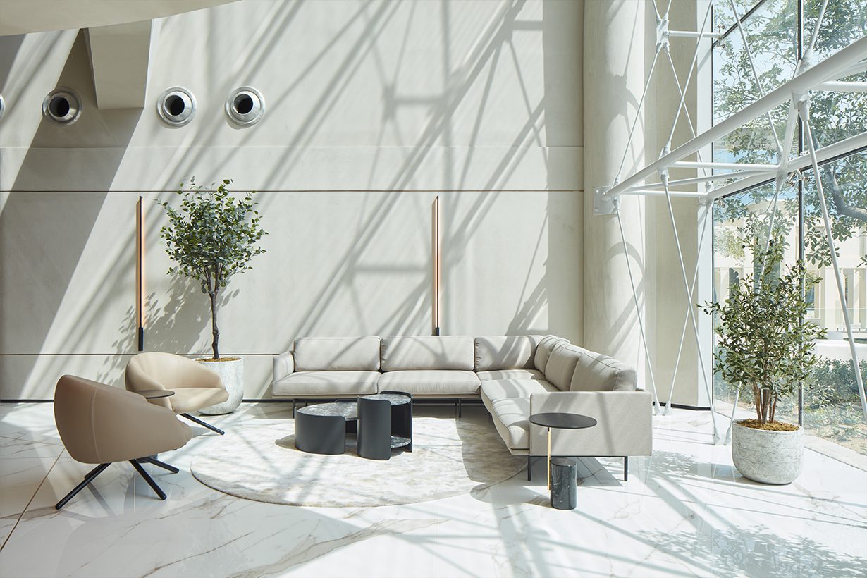 Project by Roar Bright living room with a large window, showcasing a cosy couch for relaxation. By the Roar, a firm from the middle east.