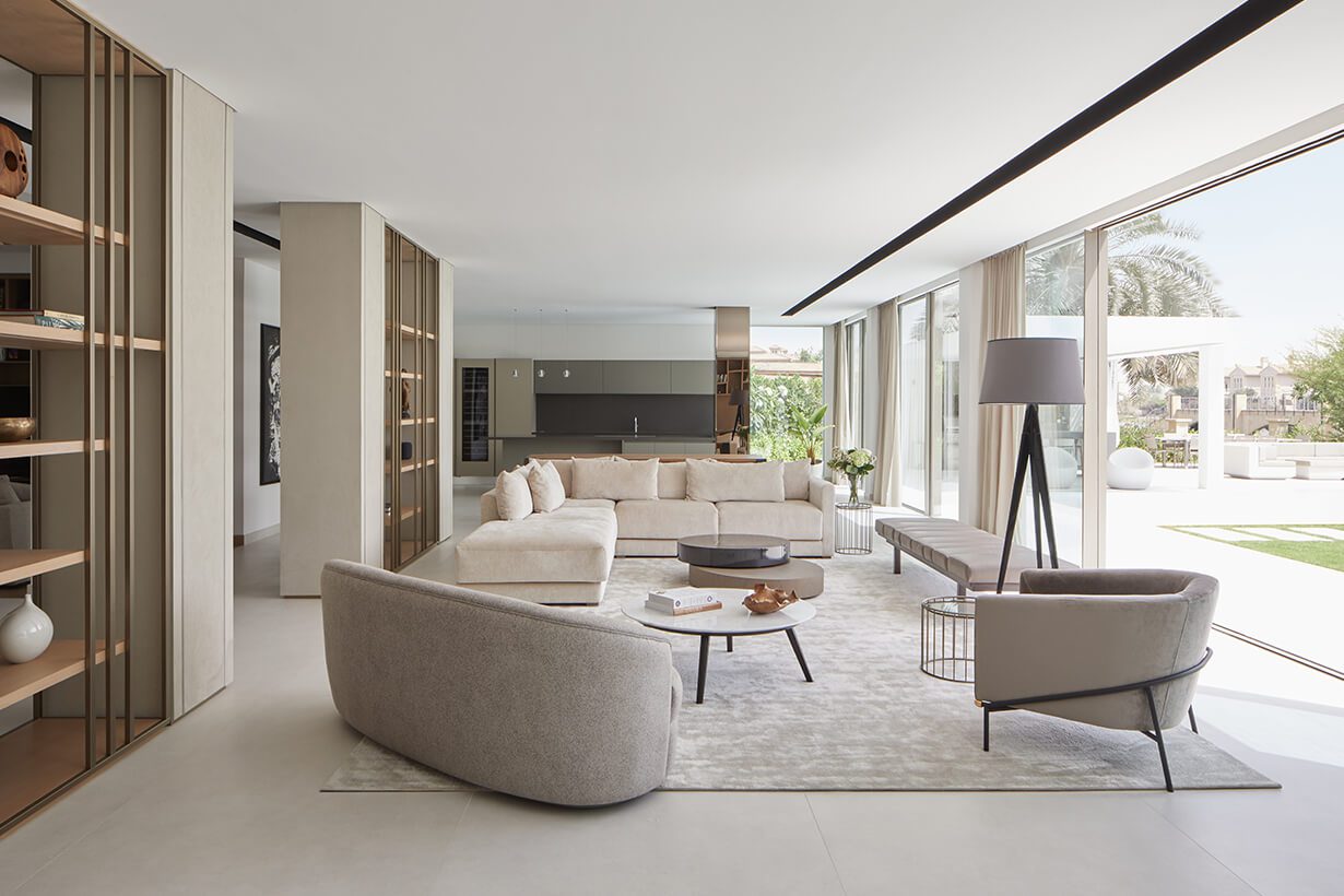 ROAR living room project in white by The Best Interior Designers In UAE. It has two white sfas and a white armchair. In a minimalist and modern style.