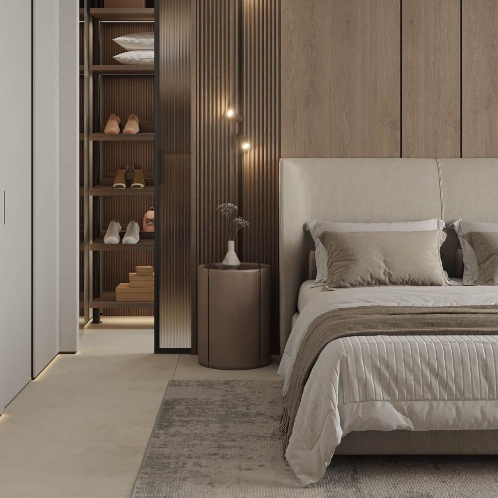 Rental 12 project Azulis Aramis (3) Modern bedroom with a beige bed and pillows, wooden accent wall, and open closet showcasing shelves with shoes. Soft lighting adds warmth.