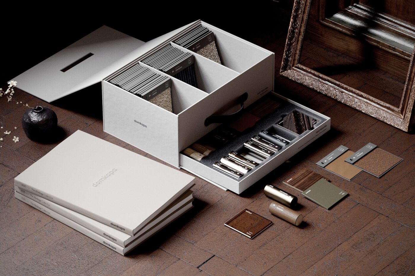 Sample box and catalogue by Domkapa A wooden floor features a box of materials alongside a mirror, adding a touch of everyday life to the scene.