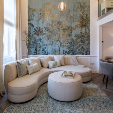 Stella Sofa in La Fenice Project Living room with stella sofa in white and rachel pouf also in white. The pouf is placed in front of the sofa and it's doing the coffee table job.