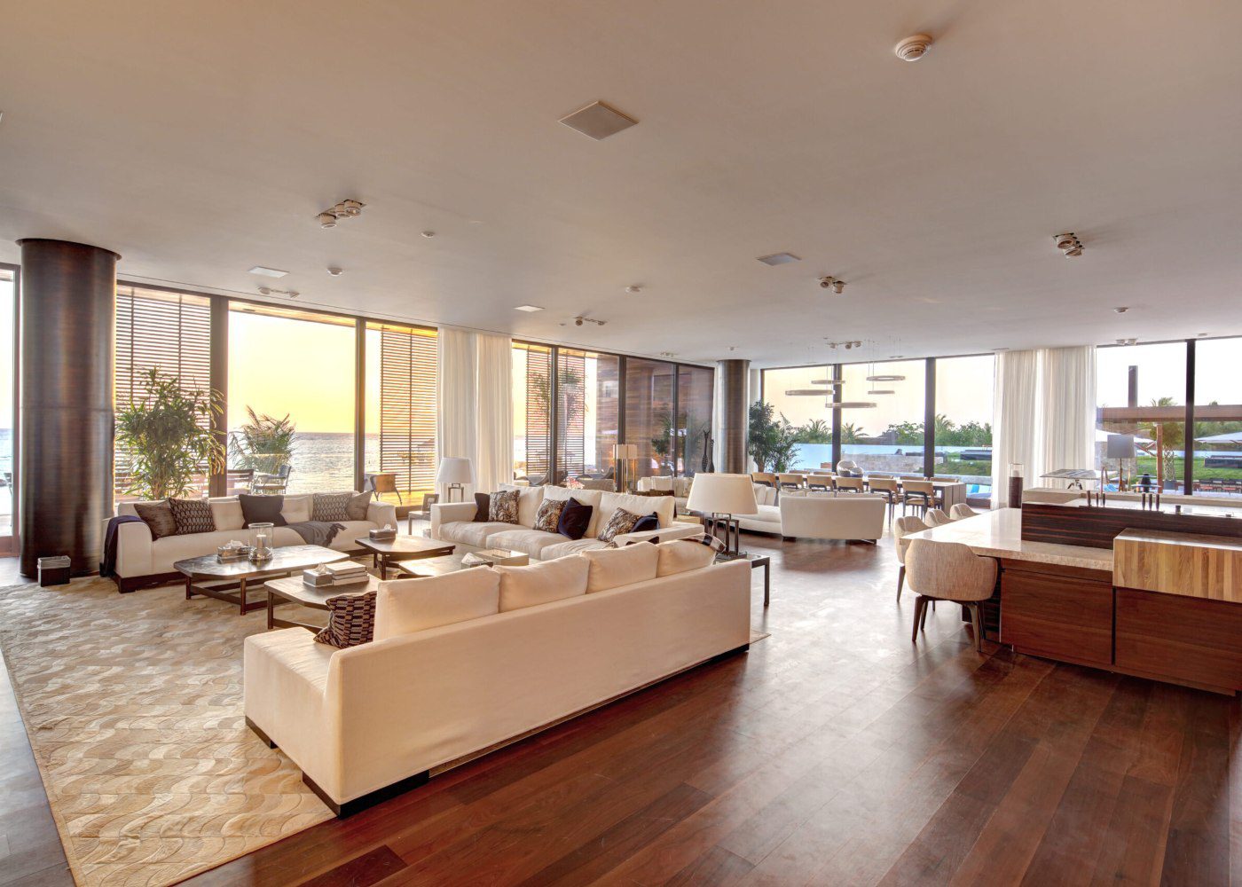 UDG project (1) A bright living room with a large window providing a picturesque view of the tranquil water beyond.