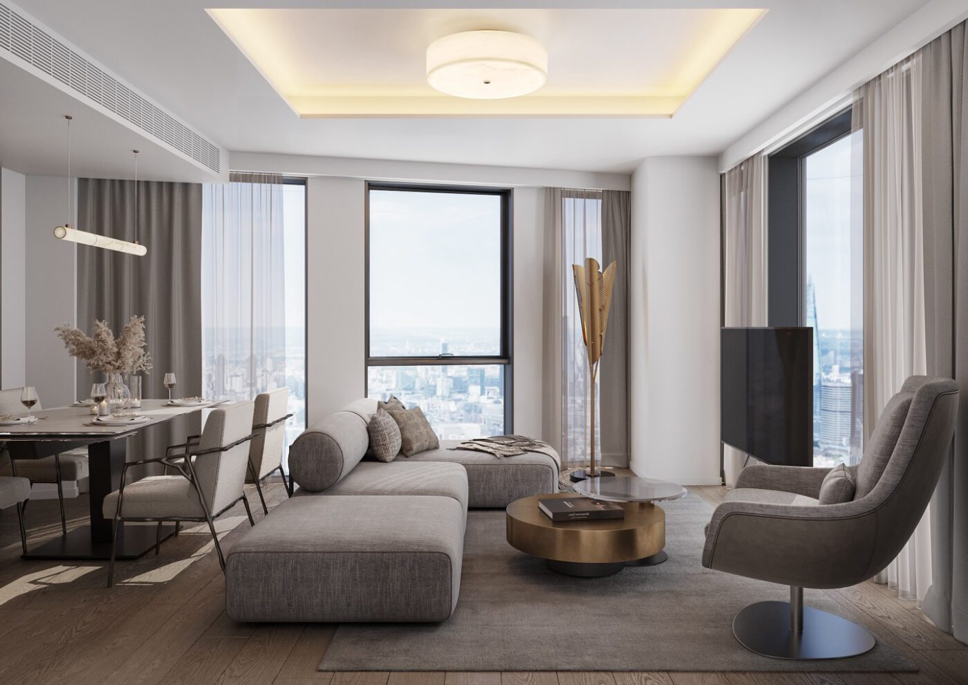 VMD Studio with Shinto Sofa and Elba A modern living room with a city view features a gray sectional sofa, a round coffee table, and a sleek armchair. Floor-to-ceiling windows let in natural light, and a dining area with a table and chairs is visible on the left. By one of the most Influential Interior Designers In The UK