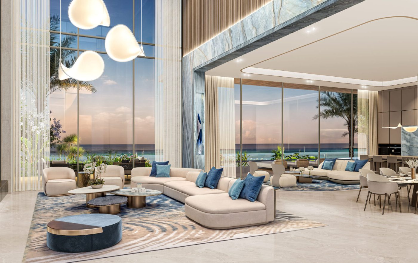 XBD Collective project (1) open space with two living rooms and a dining room. With a large window with a view to the ocean. The furniture is manly white with blue accents and some wood finishes.