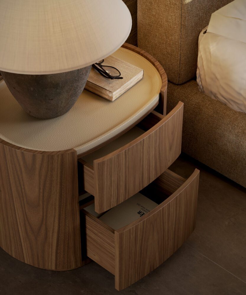A wooden bedside table featuring drawers and a lamp, ideal for nighttime reading and storage. Bedroom essentials.