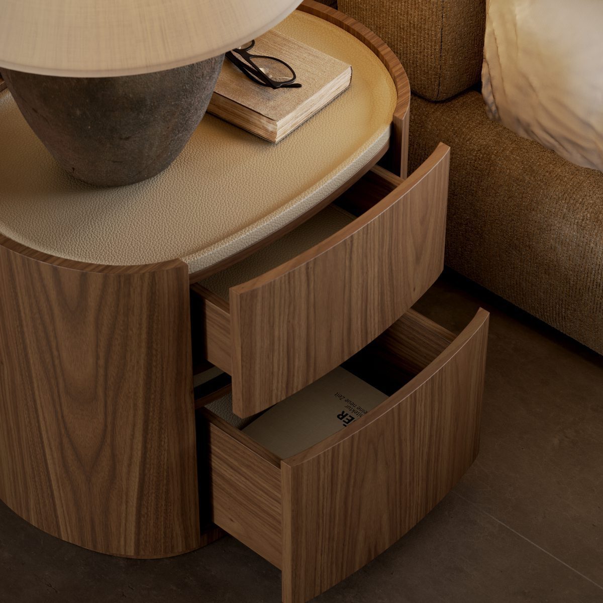 adeline bedside table with open drawers A bedside table with two drawers and a lamp, creating a cosy and functional nightstand setup in a bedroom design.