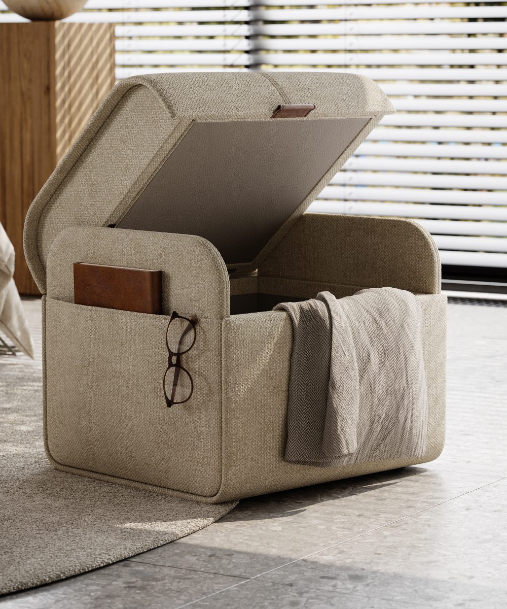 adley pouf open A compact pouf with a folded blanket and a pair of glasses placed beside it.