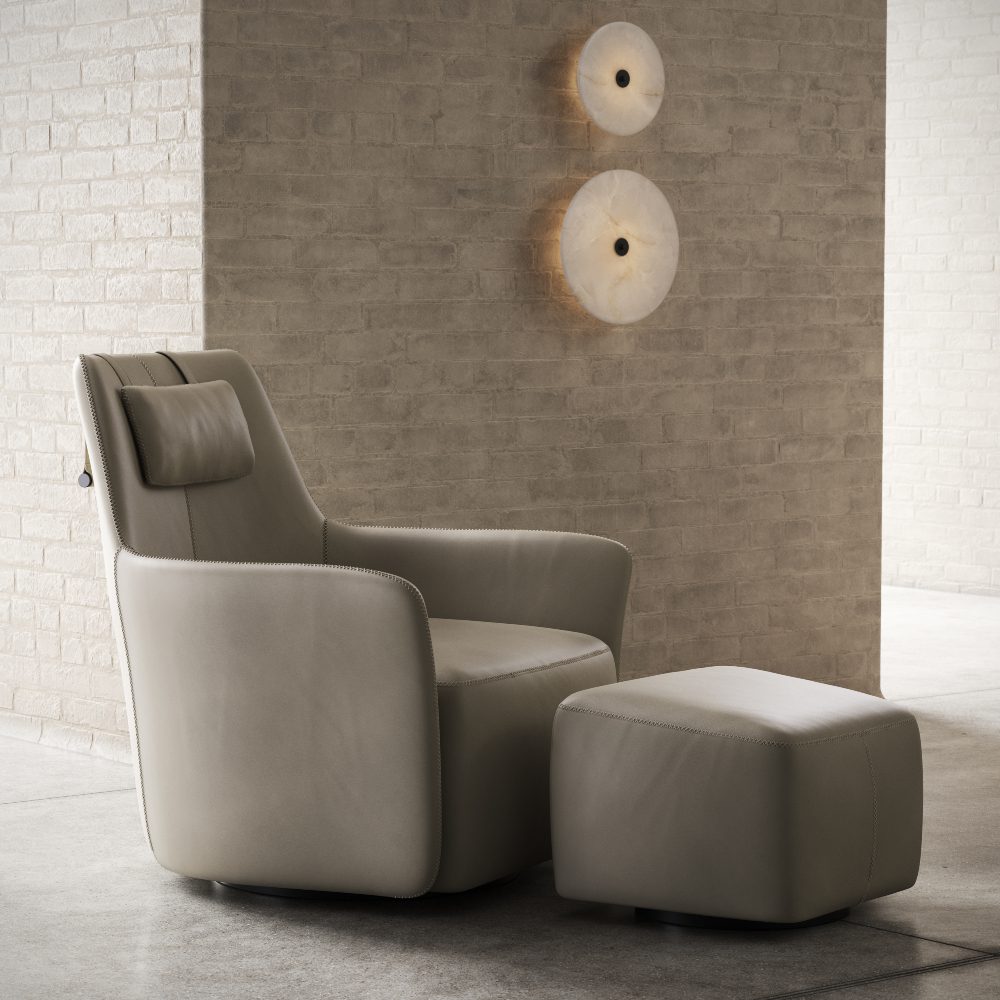 A sleek armchair and ottoman placed before a brick wall, emphasising a modern aesthetic in interior decor.