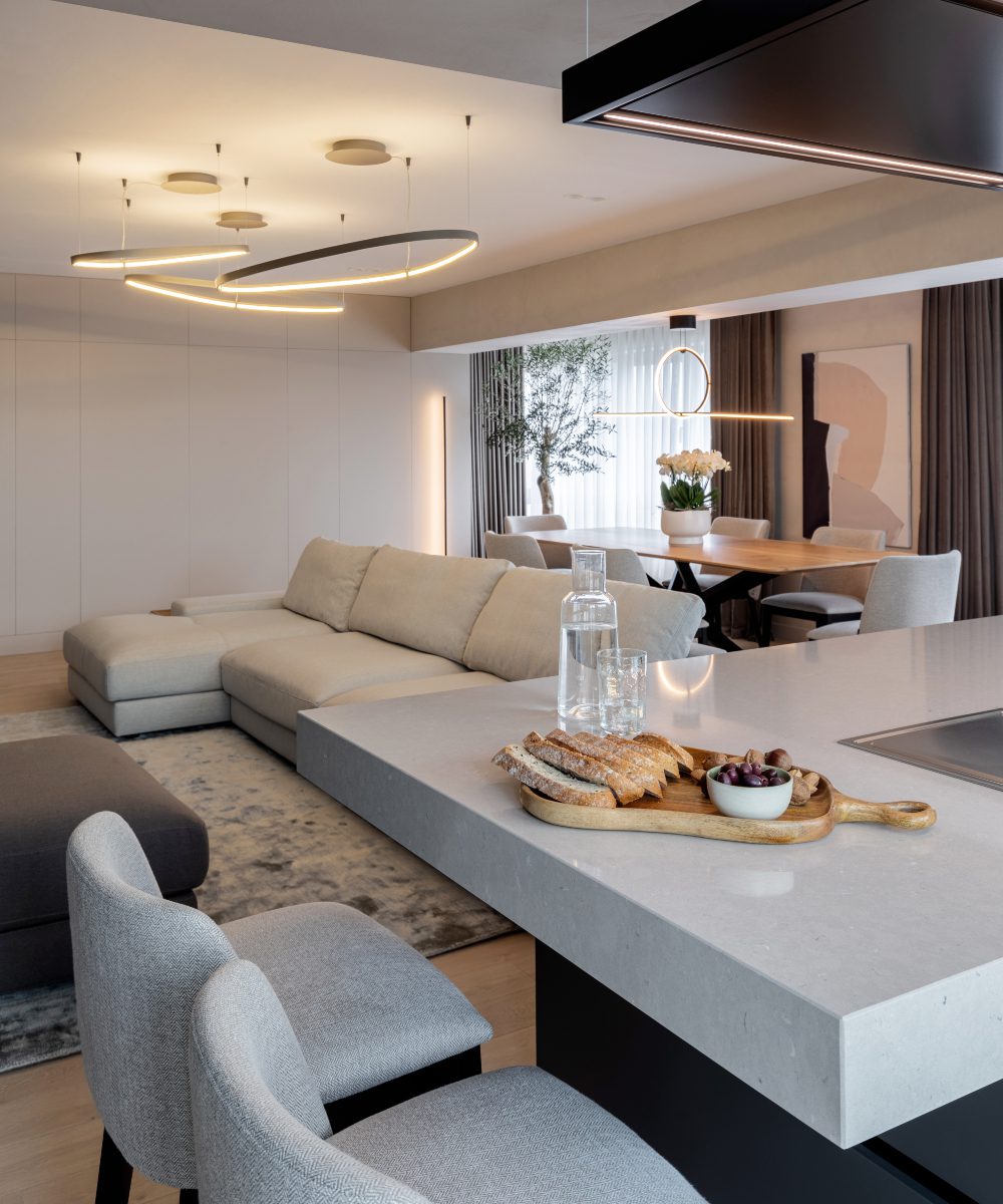 apunct studio kitchen Contemporary kitchen showcasing white countertops and trendy modern lighting.