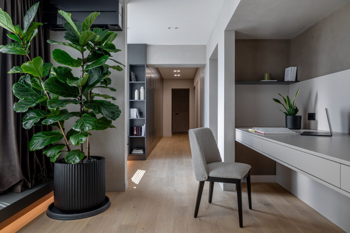 apunct studio project bedroom A stylish modern bedroom with a green plant in the corner, enhancing the room's aesthetic and promoting a calming vibe.