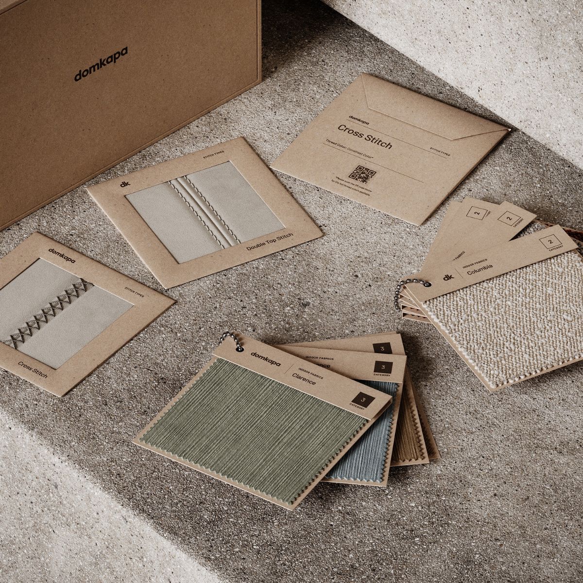 An open box filled with various fabric swatches, showcasing a mix of colours and textures.