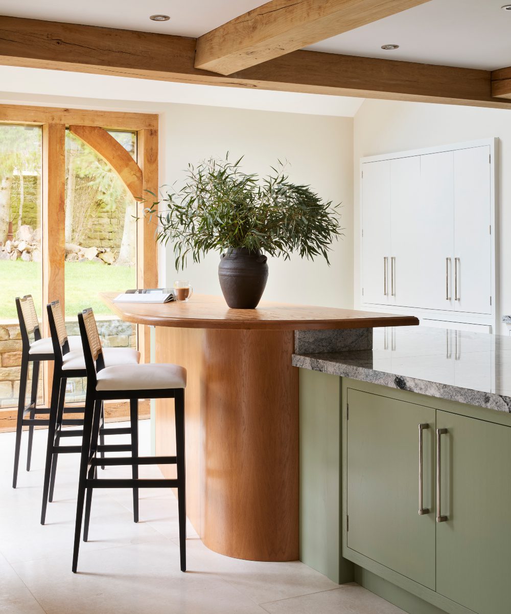 eva bar chair by domkapa at katie watkinson project Bright kitchen in a modern heritage home showcasing a large island and comfortable bar chairs, creating a welcoming space for meals and conversation.