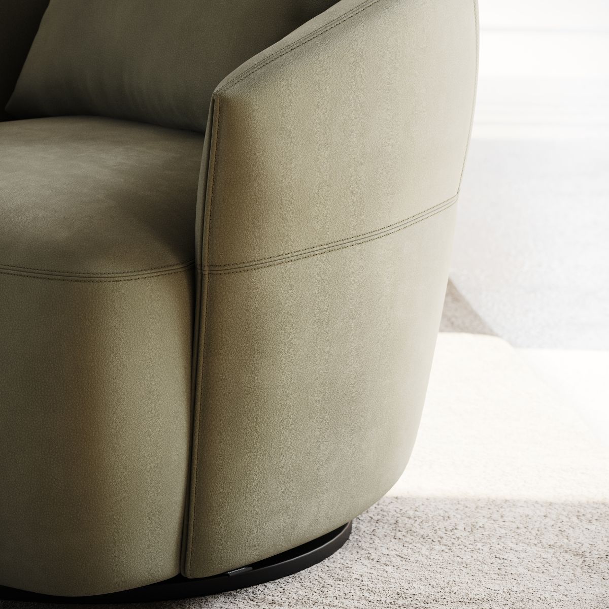 Sleek green upholstered armchair with a round back and subtle stitching detail, set on a soft beige carpet. The scene feels modern and inviting.