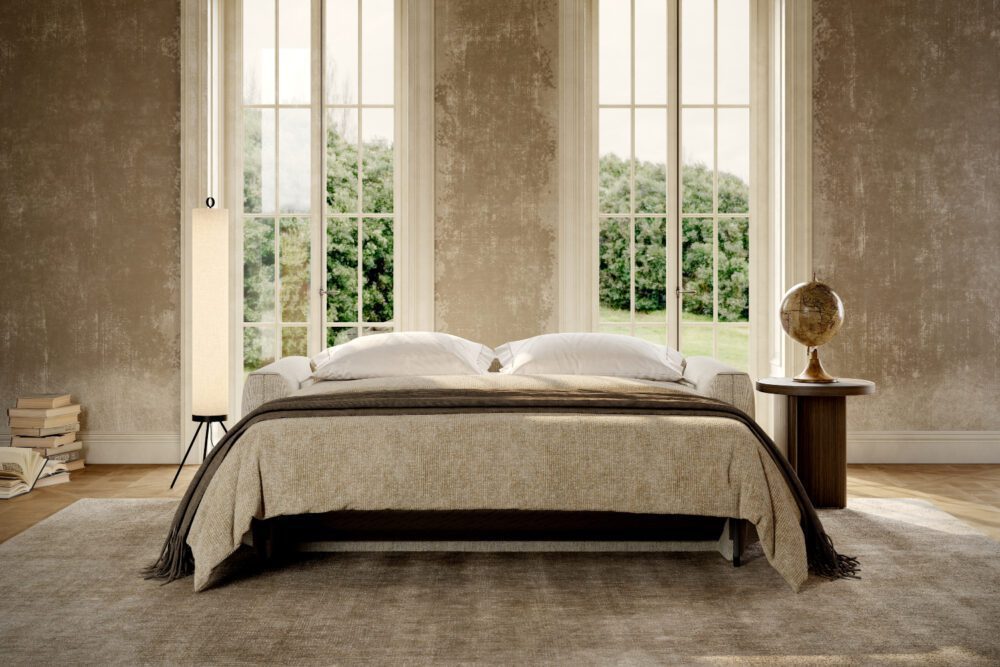 jacques sofa bed open A cosy living room featuring a sofa bed, a bedside lamp, and a window letting in natural light.