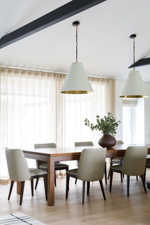 Louise chair in Quirc Interior Design Project An elegant dining room with a wooden table and chairs, designed for comfort and social dining experiences.